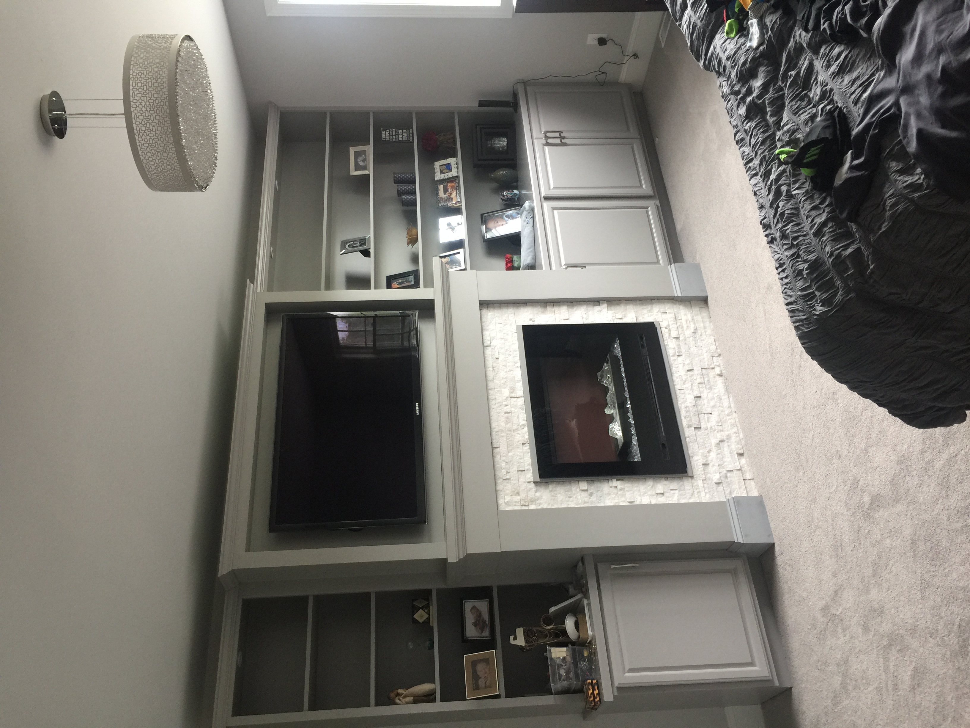 Home networking setup in a cozy living room with a wall-mounted TV above a fireplace, integrated with shelves and cabinets.